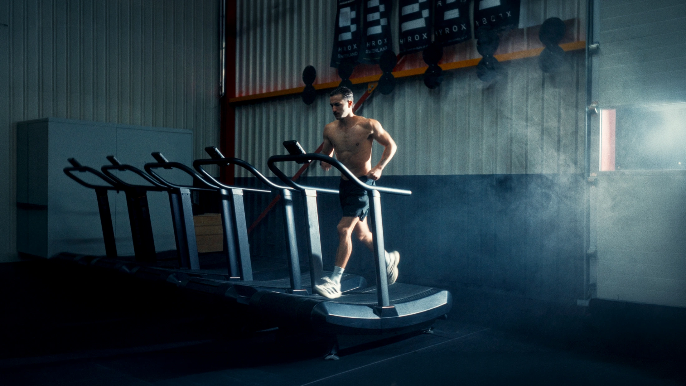 Cinematic still from Beyond Performance documentary: athlete Dariell Heim mid-stride on a curved treadmill, shot by Lua Hell