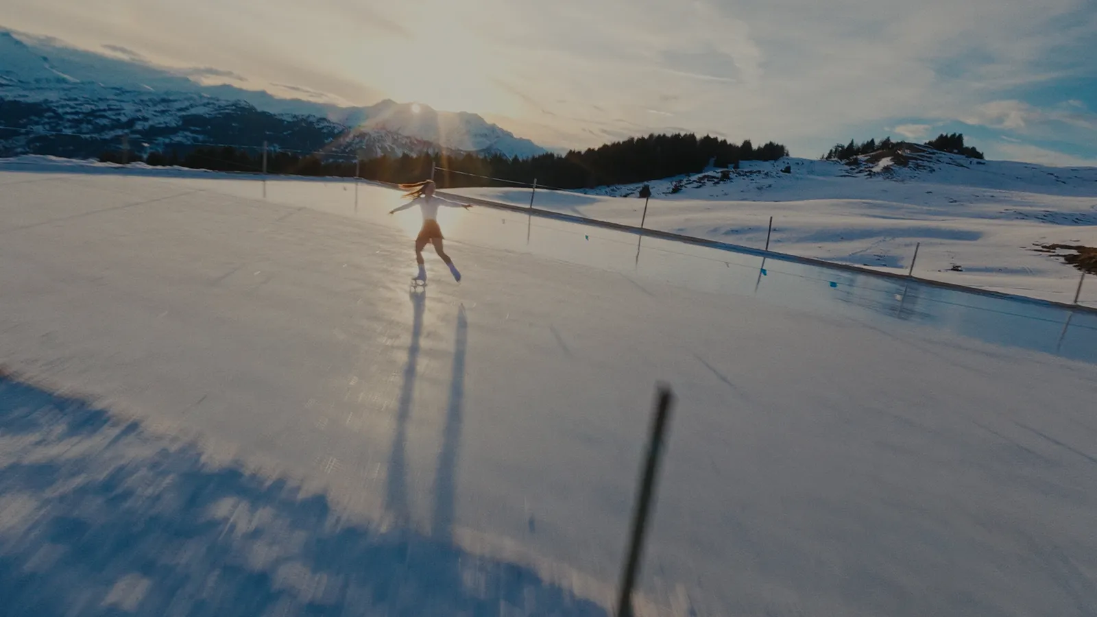 Wide behind the scenes shot from the DJI Action 6 brand video, showing the alpine ice skating production directed by Lua Hell and David Muller